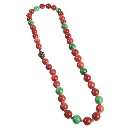 1085 - A Chinese green and russet jade bead necklace with silver filigree clasp. The largest bead is 13.5mm... 