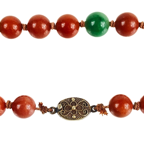 1085 - A Chinese green and russet jade bead necklace with silver filigree clasp. The largest bead is 13.5mm... 