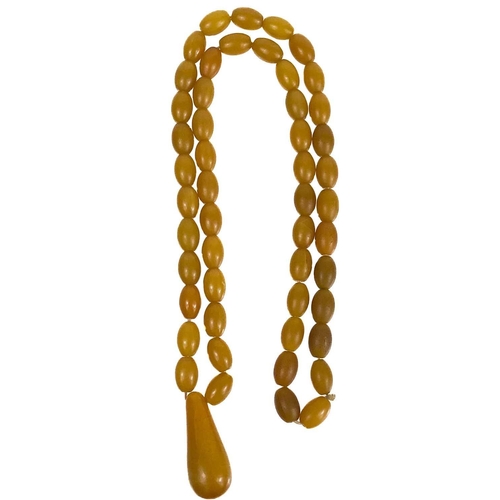 1086 - A butterscotch 'amber' style oval bead necklace. With a large pear shaped pendant, length of pendant... 