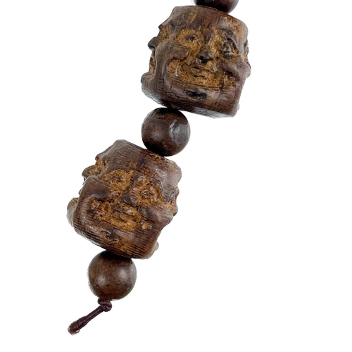 1089 - A strand of five Chinese carved hardwood Buddha head beads. Each comprising of four jovial and sad f... 