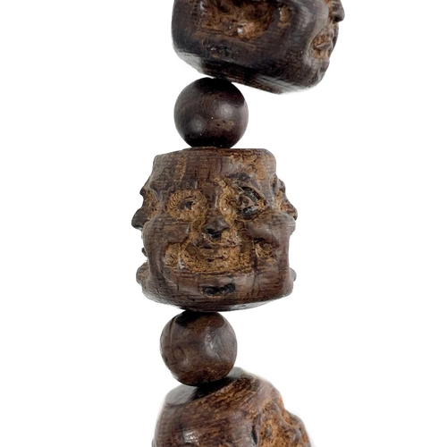 1089 - A strand of five Chinese carved hardwood Buddha head beads. Each comprising of four jovial and sad f... 