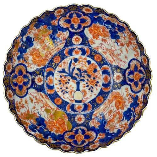 1114 - A Japanese Imari porcelain bowl, 19th century. The interior with a central roundel enclosing a vase ... 