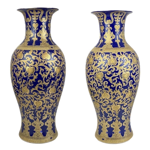 1480 - A large pair of contemporary Chinese porcelain vases. Each with a blue ground and gilt foliate decor... 