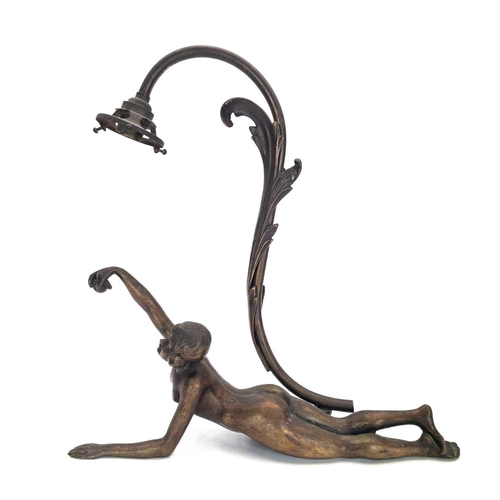 10 - An Art Deco bronze figural table lamp. Modelled as a prone Eve with the apple, stamped F R 696 to th... 