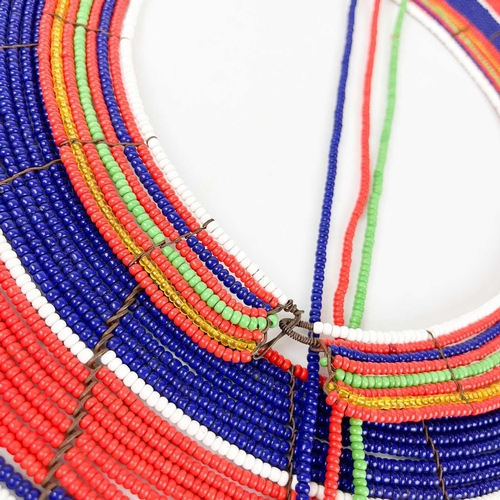 102 - A Maasai beaded wedding collar. Together with a ceremonial sheild. (2)