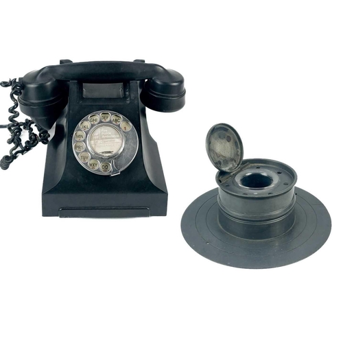 134 - A black Bakelite telephone circa 1930. Central paper label Penzance, together with a large pewter ca... 