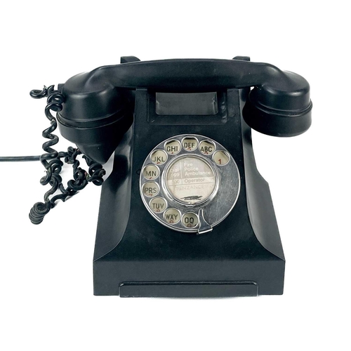 134 - A black Bakelite telephone circa 1930. Central paper label Penzance, together with a large pewter ca... 