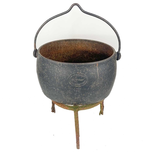 137 - A circular cast iron cauldron. Diameter 28cm together with other cast iron cauldrons and trivets.