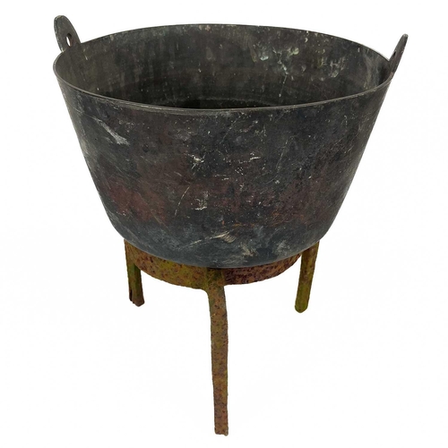 137 - A circular cast iron cauldron. Diameter 28cm together with other cast iron cauldrons and trivets.