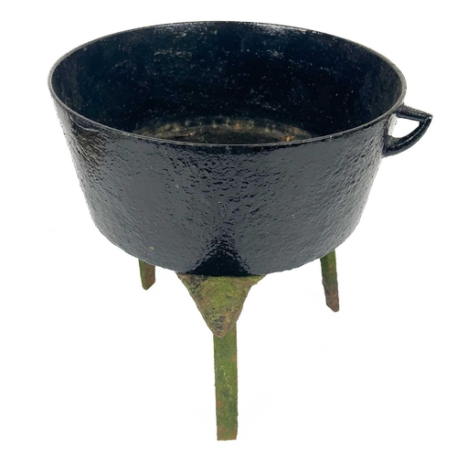 137 - A circular cast iron cauldron. Diameter 28cm together with other cast iron cauldrons and trivets.