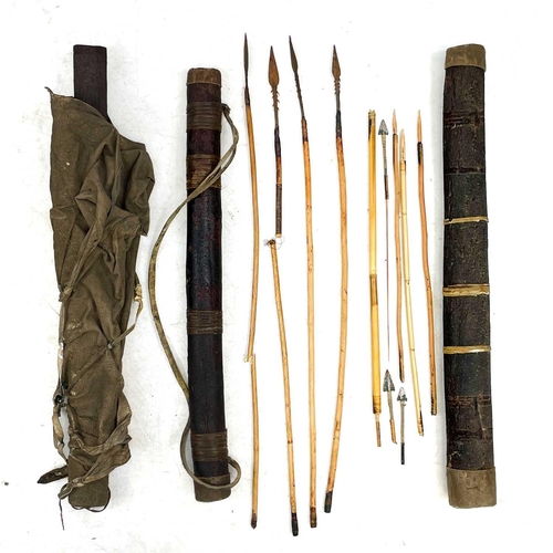 139 - A collection of African tribal hunting implements. Including bark and hide quivers containing arrows... 