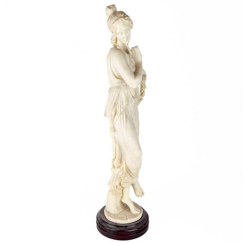 146 - A composite figure of a neo-classical maiden. On wooden base, height 67cm.