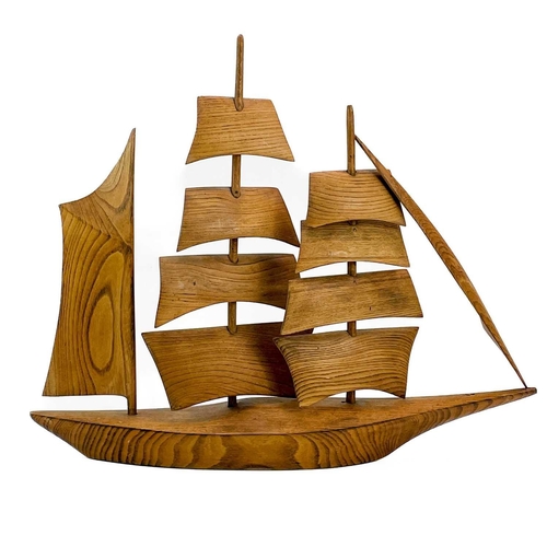 148 - A Cornish carved elm model of a sailing ship. Mid 20th century, with well figured grain, height 47cm... 