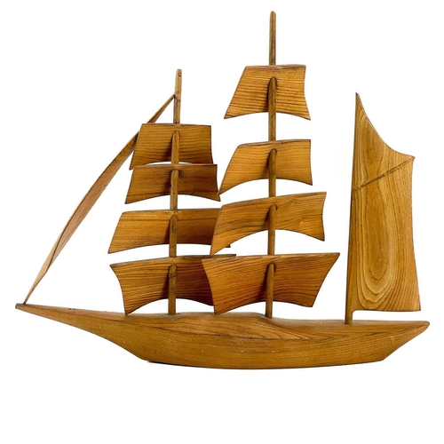 148 - A Cornish carved elm model of a sailing ship. Mid 20th century, with well figured grain, height 47cm... 