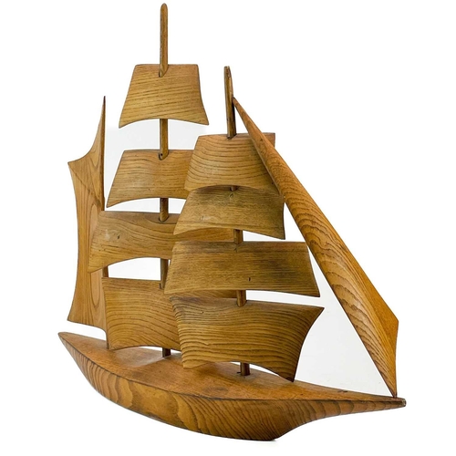 148 - A Cornish carved elm model of a sailing ship. Mid 20th century, with well figured grain, height 47cm... 