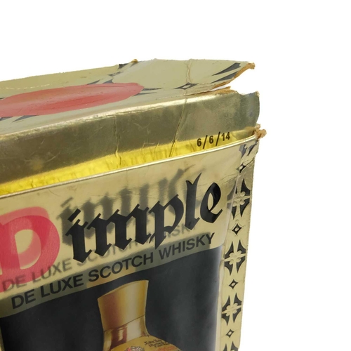 16 - A bottle of Dimple De Luxe Scotch Whisky. 70% Proof 26 2/3 Fl.Ozs in the original box.