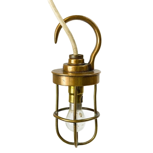 17 - A brass cage engine inspection lamp by B M A C Ltd. Stamped A.P 6662, length 16cm, together with a b... 