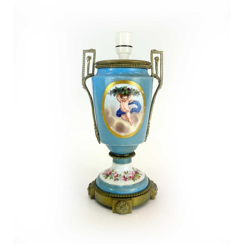 170 - A Paris porcelain lamp base. Circa 1880, painted with a cherub and flowers, with gilt metal mounts, ... 