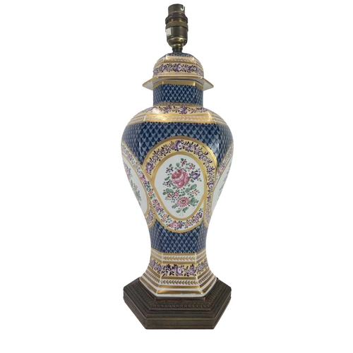 170 - A Paris porcelain lamp base. Circa 1880, painted with a cherub and flowers, with gilt metal mounts, ... 