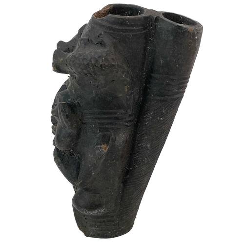 179 - An African clay pipe. Moulded with three heads, length 54cm, together with three other similar pipes... 