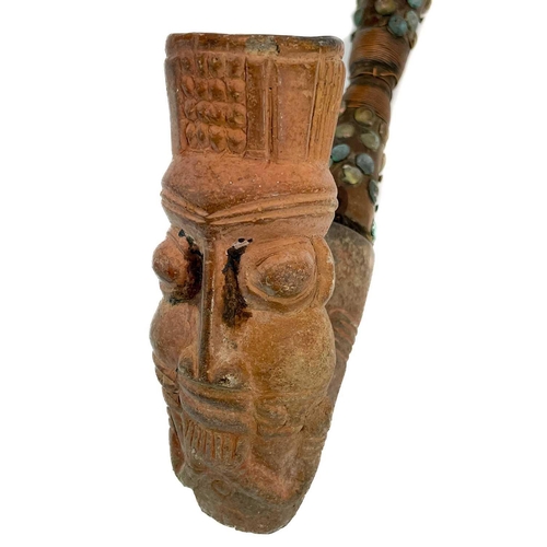 179 - An African clay pipe. Moulded with three heads, length 54cm, together with three other similar pipes... 