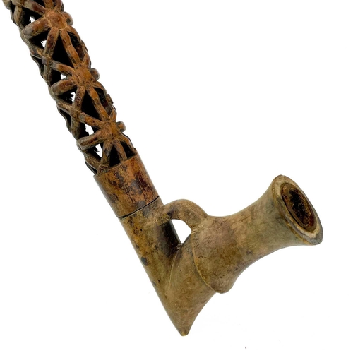 179 - An African clay pipe. Moulded with three heads, length 54cm, together with three other similar pipes... 