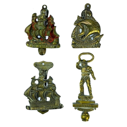 191 - A collection of twenty-eight brass souvenir novelty door knockers. (28).