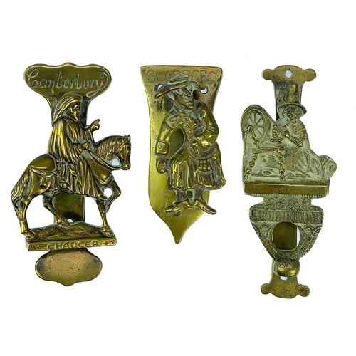 191 - A collection of twenty-eight brass souvenir novelty door knockers. (28).