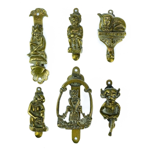 191 - A collection of twenty-eight brass souvenir novelty door knockers. (28).