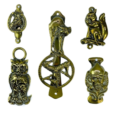 191 - A collection of twenty-eight brass souvenir novelty door knockers. (28).