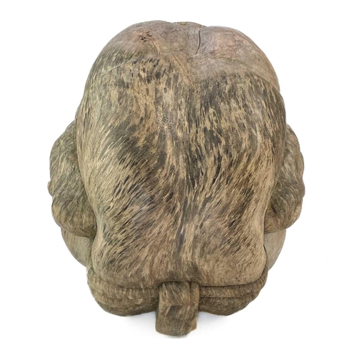 195 - A 'weeping Buddha' hand carved wooden statue. Height 33cm, width 28cm, depth 46cm.