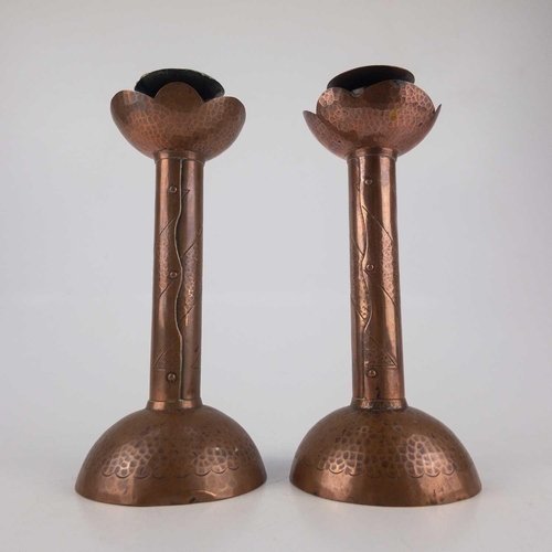 2 - Herbert Dyer (1898-1974). A pair of Cornish copper candlesticks with repousse and chased decoration ... 