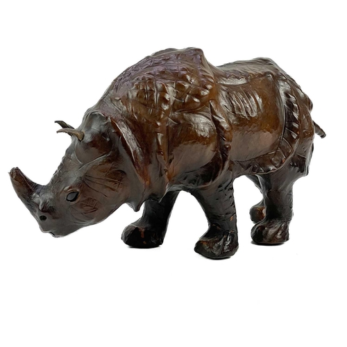 210 - A leather model of a rhinoceros. Height18.5cm, length 32cm.