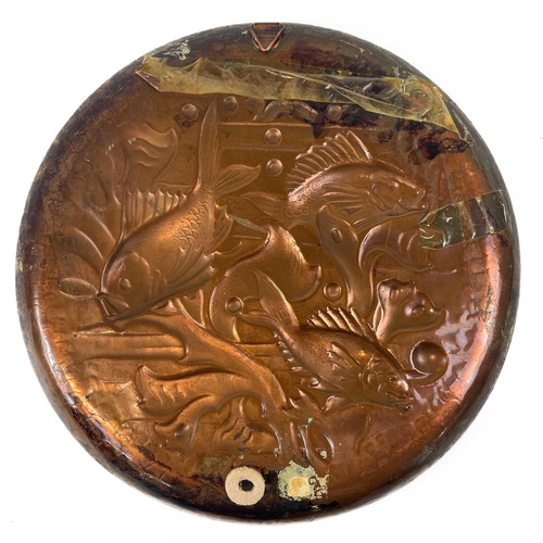 212 - A Newlyn circular copper shallow dish. Repousse and chased decorated with fish amongst seaweed, diam... 