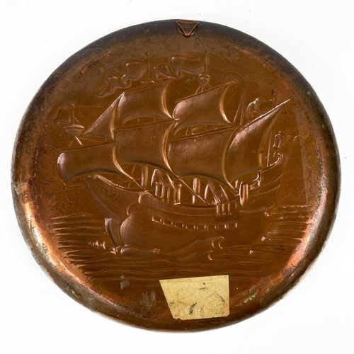 213 - A Newlyn copper circular shallow dish. Repousse and chased decorated with a galleon, diameter 33cm. ... 