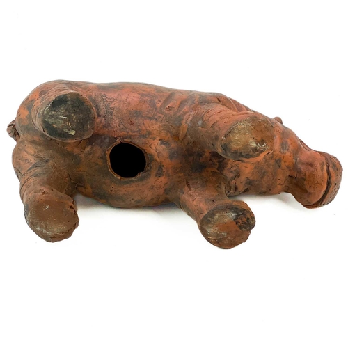 214 - A sculpture of a hippo cast in terracotta. Height 23cm, length 51cm.