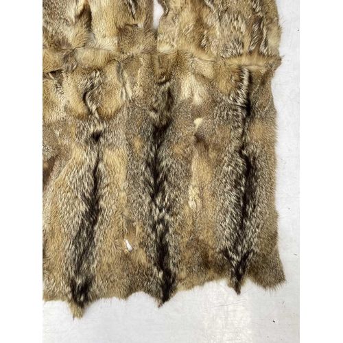 218 - An Argentine wolf tail skin rug. Approximately 200cm x 140cm,