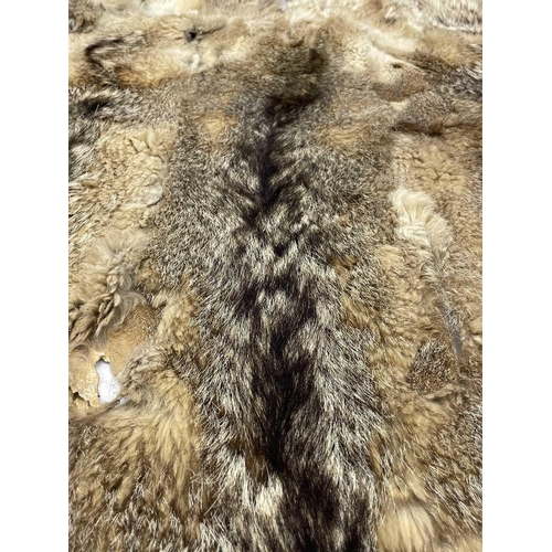 218 - An Argentine wolf tail skin rug. Approximately 200cm x 140cm,