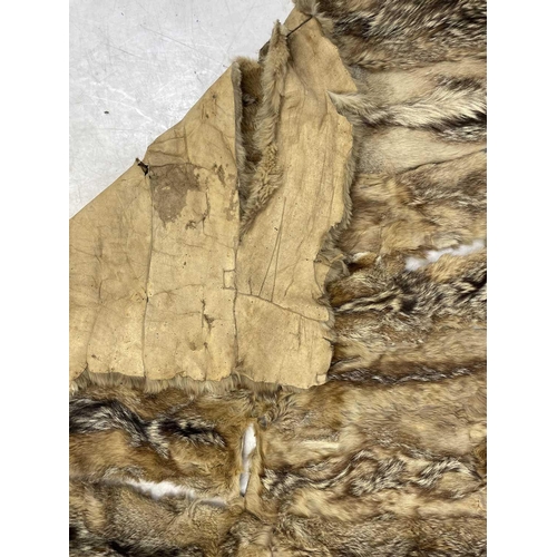 218 - An Argentine wolf tail skin rug. Approximately 200cm x 140cm,