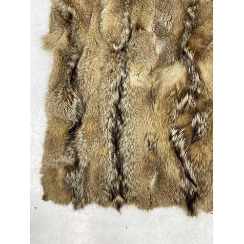 218 - An Argentine wolf tail skin rug. Approximately 200cm x 140cm,