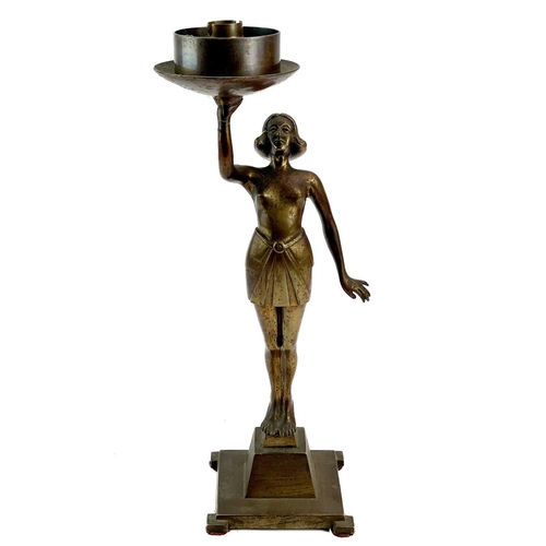 222 - An Art Deco cast metal figural table lamp. Modelled as a standing female dancer holding a large glas... 