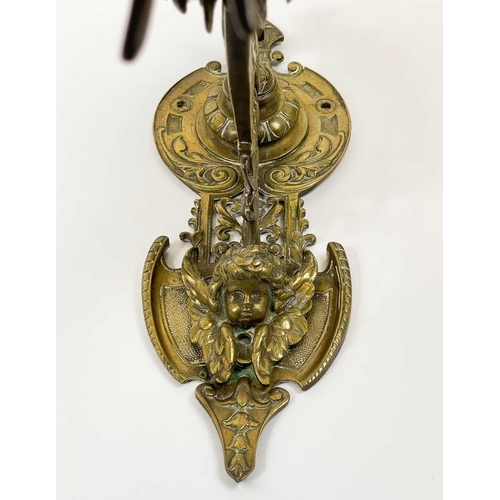 227 - An ornate late Victorian brass bell and wall bracket Cast with cherubs and scrolling foliage, overal... 