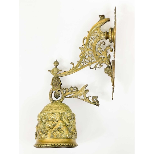 227 - An ornate late Victorian brass bell and wall bracket Cast with cherubs and scrolling foliage, overal... 