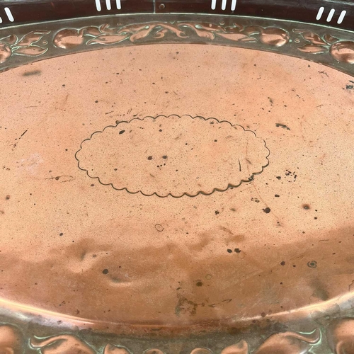 247 - A Newlyn copper oval galleried tray. With twin handles, repousse decorated to the border with a band... 