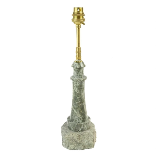 26 - A Cornish serpentine lighthouse lamp.. On a rocky base, height 36cm.