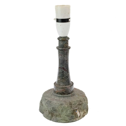 27 - A Cornish serpentine lighthouse table lamp. On a rocky base, height 27cm.