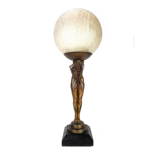 281 - Max Le Verrier (1891-1973) An Art Deco gilt bronze figural table lamp with a crizzled glass shade on... 