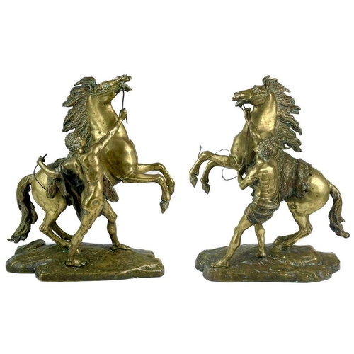 285 - A substantial pair of brass Marly horses, After Coustou. Each with stamped signature on the rockwork... 