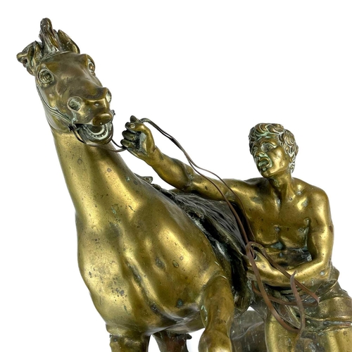 285 - A substantial pair of brass Marly horses, After Coustou. Each with stamped signature on the rockwork... 