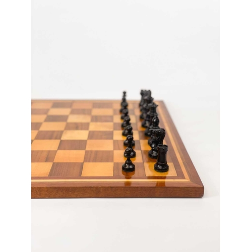 30 - A boxwood and ebony chess set. In a mahogany box, another chess set, and an inlaid chess board.